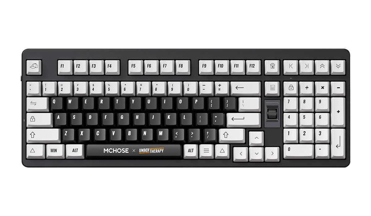 Czarno-biała klawiatura MCHOSE x Unbox Therapy z wyraźnymi klawiszami i logo na dolnym rzędzie.