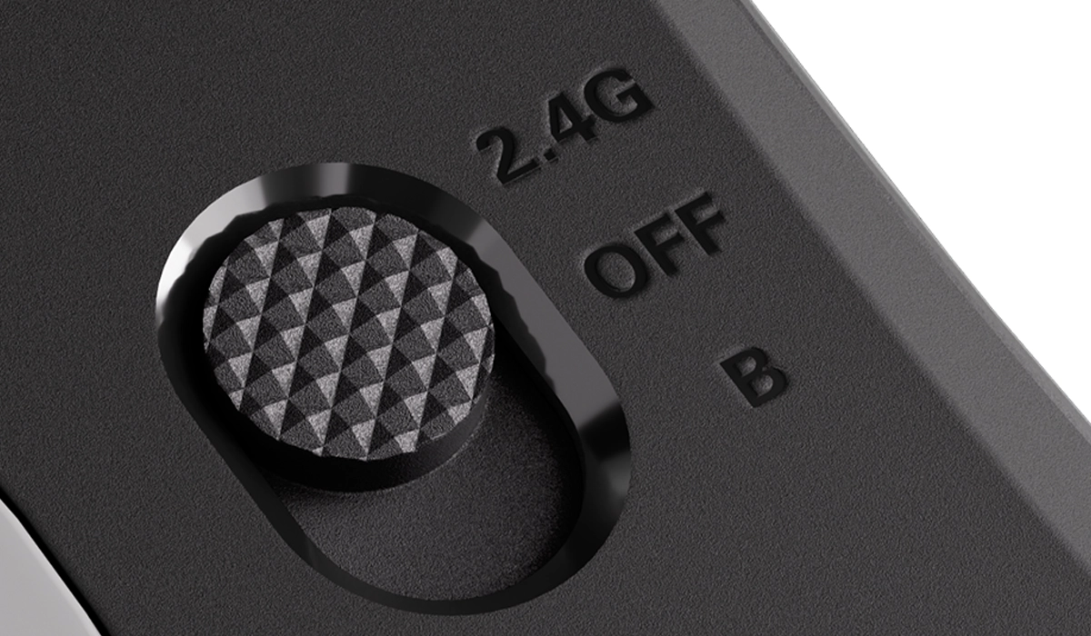 Czarno-szary przełącznik z trzema pozycjami: 2.4G, OFF i B, z teksturowanym uchwytem.